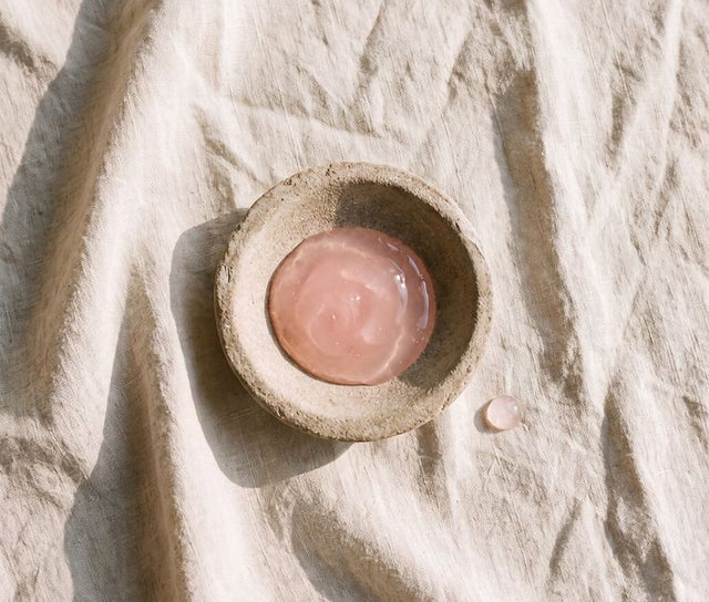Pale rose-pink gel pooled in a stone dish