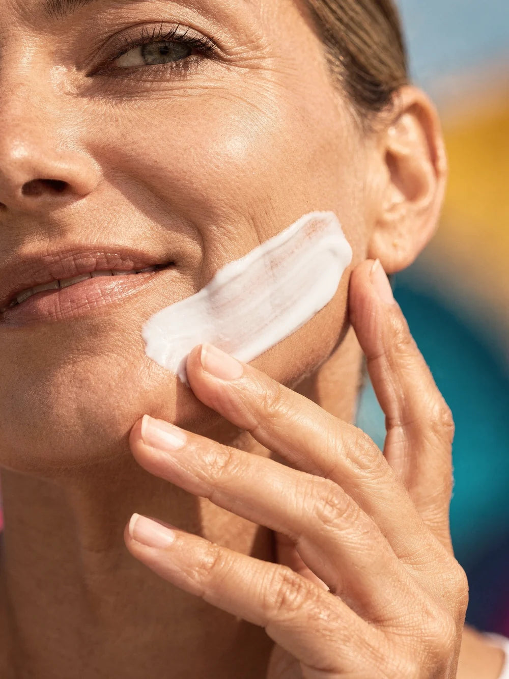 Cream swept upward and outward along the jaw with two fingers